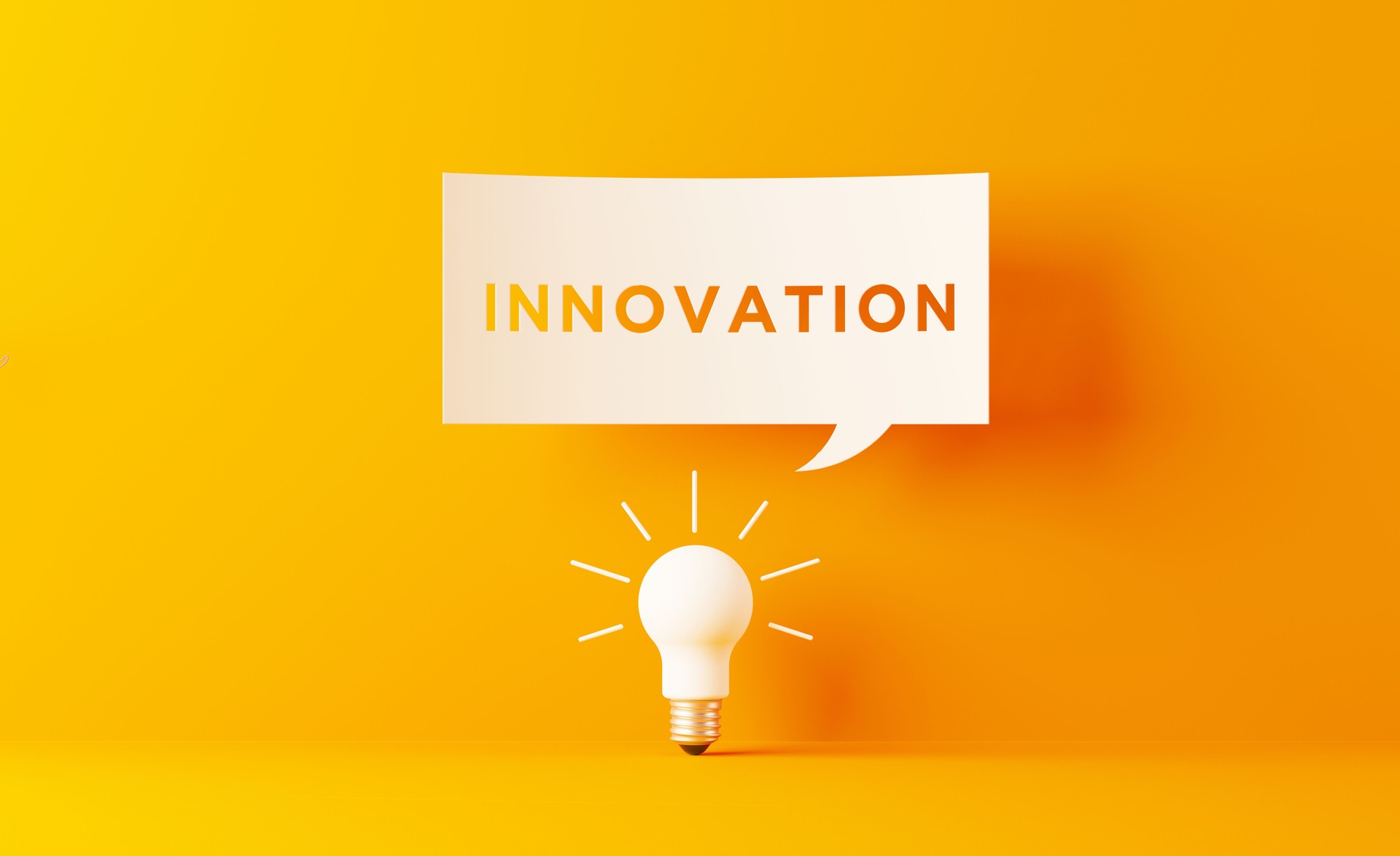 Light Bulb And White Speech Bubble On Yellow Background